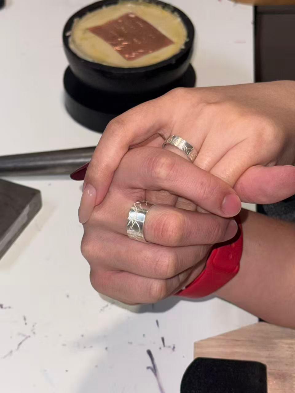 Handmade silver rings worn together
